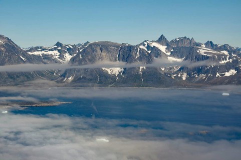 Iceberg, ice and islands, in a fjord, aerial view, rough, snow-covered rough, snow-covered mountain