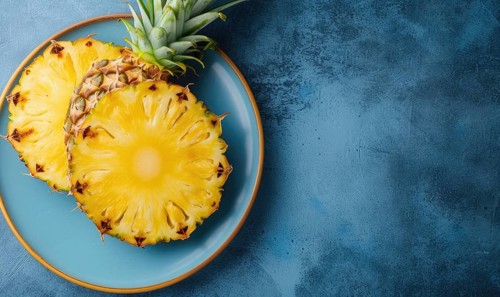 Pineapple slices on blue plate over blue background. Top view with copy space AI generated