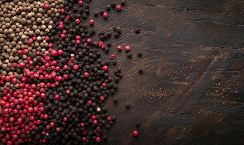 Black and pink pepper mix on wooden background. Top view with copy space AI generated