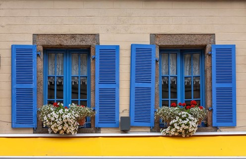 House facade with two windows, blue window frames and blue shutters, Roscoff, Bretagne, France,