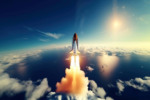 Aerial view of a rocket shuttle carrier launch at sunrise over an ocean coast. The rocket is