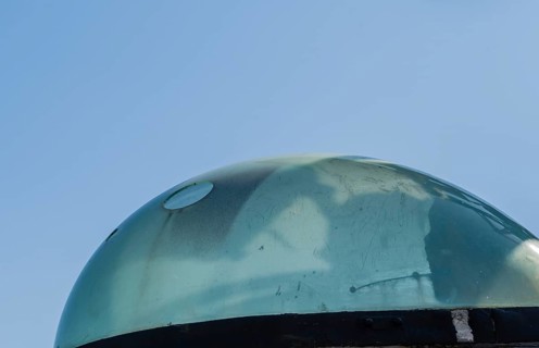 Plexiglass dome covering the slewing sight on battleship gun fire-control system on display public
