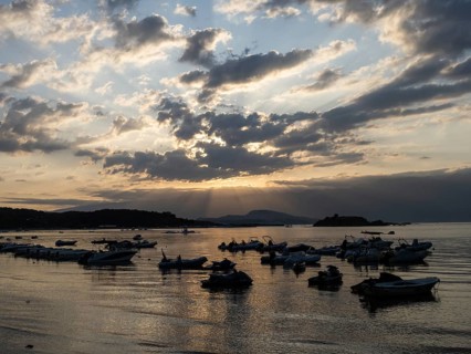 Boats at anchor, morning atmosphere on the beach at sunrise, Lopar, island of Rab, Kvarner Gulf