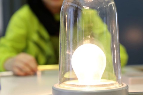 Child conducting a physics experiment with a simple circuit