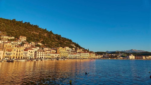 The blue hour brings peace to the coastal landscape and is reflected in the calm sea, Taygetos