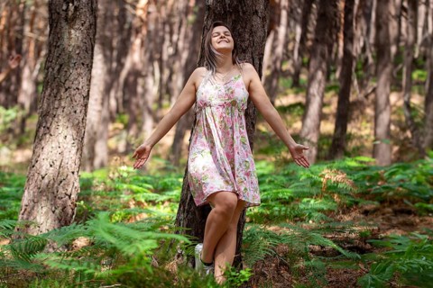 Young woman bathing in the forest (Shinrin Yoku), nature therapy from Japan