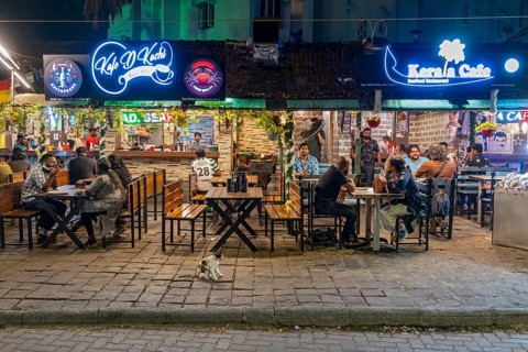 Diners enjoy a lively evening at a street-side restaurant on Tower Road, Fort Kochi, Cochin,