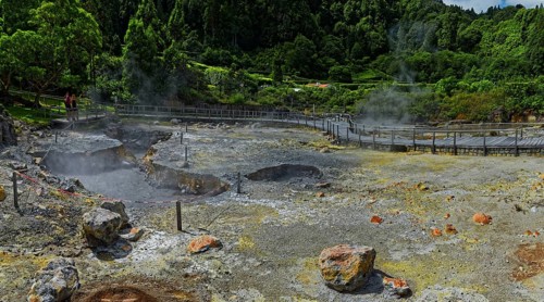 Geothermal activity with steaming mud holes and rock formations in an impressive landscape,