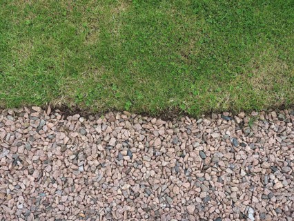 Green meadow and gravel background