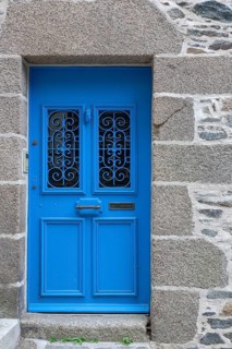 Natural stone house facade with a blue entrance door, Morlaix, Departements Finistere, Brittany,