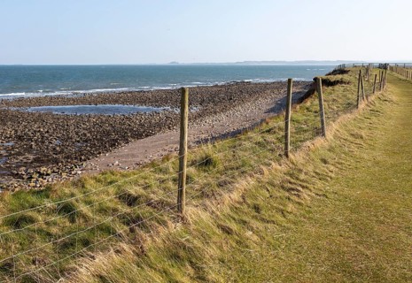 Coastline landscape scenery looking south towards Farne Islands, Holy Island, Lindisfarne,