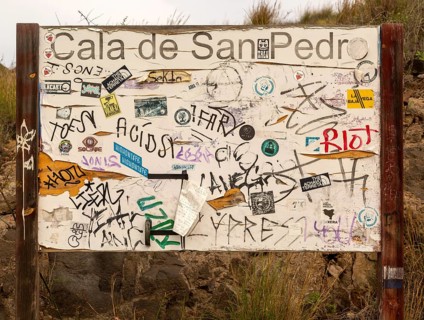 Hippy graffiti painted on noticeboard, abandoned village of Cala de San Pedro, Cabo de Gata Natural