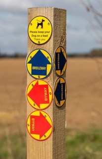 Close up of wooden post with byway and bridleway direction pointer signs, Sutton, Suffolk, England,