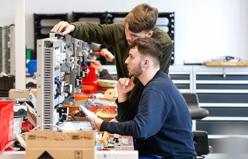 An electronics apprentice assembles a motor protection relay at a Deutsche Bahn training centre,