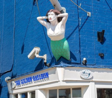 Mermaid ship's figurehead above the Golden galleon fish and chips shop, Aldeburgh, Suffolk,