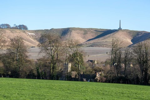 White horse, Lansdowne monument, Oldbury Camp hill fort, chalk scarp slope, Cherhill village,