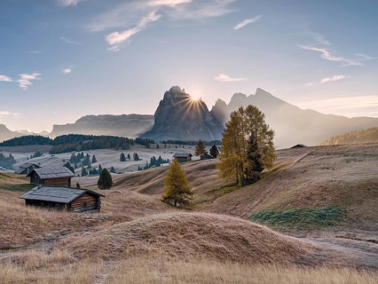 Autumn on the Seiser Alm, Alpine huts with Plattkofel and Langkofel, sunrise, sun star, frost,