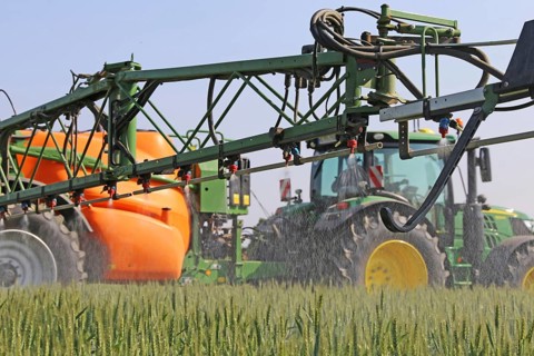 A farmer from the Schmitt vegetable farm in Hockenheim drives his tractor with a crop protection