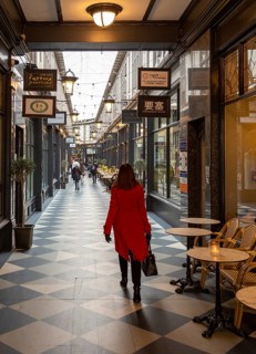 Shoppers walking in High Street arcade in city centre of Cardiff, South Wales, UK