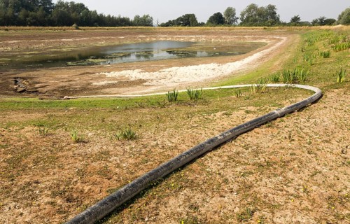 27 July 2018 Low water level in farm irrigation lake after long summer drought, Sutton, Suffolk