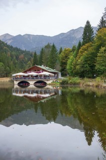 Pflegersee with inn under a cloudy sky, Garmisch-Partenkirchen, Werdenfelser Land, Upper Bavaria,