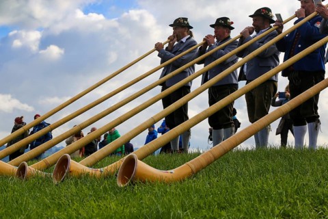 Alphorn players in Bavaria Germany . The alphorn is a traditional wind instrument in the Alps