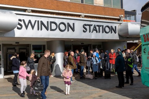 People at railway station waiting for rail replacement bus service, Swindon, Wiltshire, England, UK