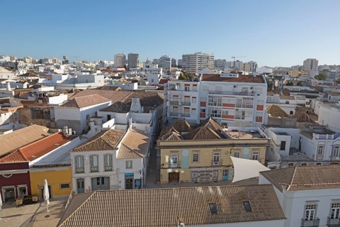 High density roof top view of buildings crowded together in the city centre of Faro, Algarve,