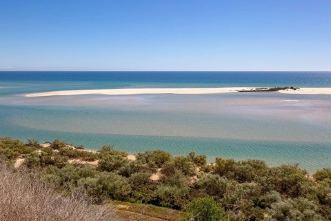 Coastal wooded landscape of pristine beaches and lagoon behind offshore sandbar, Cacela Velha, Vila