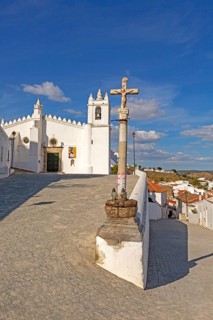 Historic whitewashed church Igreja Matrix in medieval village of Mertola, Baixo Alentejo, Portugal,