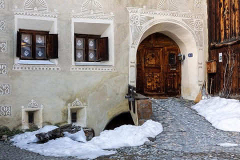 House entrance door, window, historic house, sgraffito, facade decorations, Guarda, Engadin,