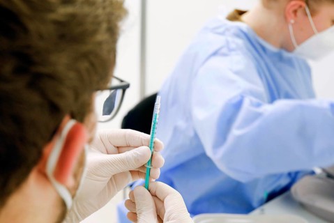 Syringes are filled with the Covid19 Biontech Pfizer vaccine Comirnaty in a vaccination centre by