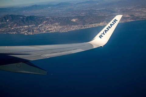 Wing of Ryanair aircraft above Mediterranean Sea over the Costa del Sol taking off from Malaga,