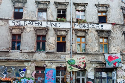Covered wall with graffiti and political messages, left-wing political, politics, house, facade,
