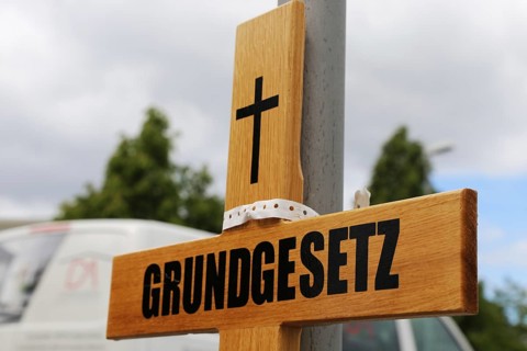 Symbolic grave cross with inscription on the Basic Law at a protest organised by critics of the