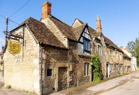 Historic former Red Lion pub in Melksham, Wiltshire, England, UK row cottages Cotswold stone