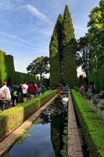 Tourists, Strollers in gardens with water basin, Generalife Gardens, Alhambra, UNESCO World
