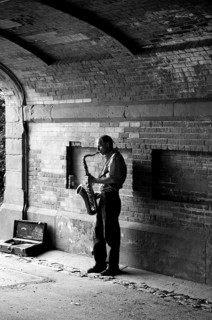 Saxophone player under a bridge in Central Park, New York City, USA, North America