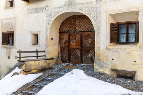 House entrance door, window, historic house, sgraffito, facade decorations, Guarda, Engadin,