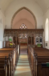 Elaborately decorated wooden rood screen in church of Saint Andrew, Bramfield, Suffolk, England, UK