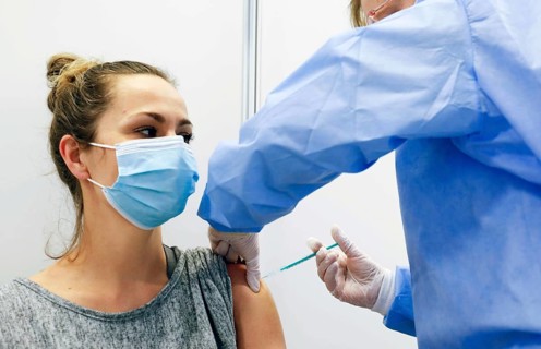 A woman receives a vaccination with Covid19 Biontech Pfizer vaccine Comirnaty in a vaccination