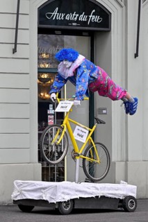 Carnival reveller flying hero on bicycle