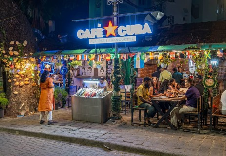 Diners enjoy a lively evening at a street-side restaurant on Tower Road, Fort Kochi, Cochin,