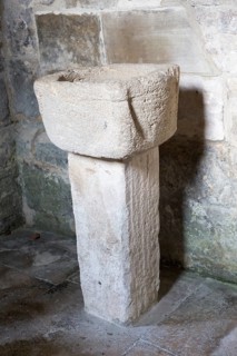 Simple stone baptismal christening font Saxon church of Saint Laurence, Bradford on Avon,