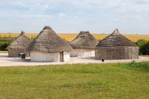 Reconstruction of neolithic homes thatched round houses huts, Stonehenge, Wiltshire, England, UK