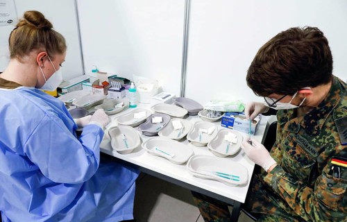 Syringes are filled with the Covid19 Biontech Pfizer vaccine Comirnaty in a vaccination centre by