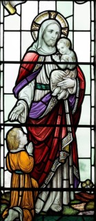 Stained glass windows in All Saints church, Lydiard Millicent, Wiltshire, England, UK