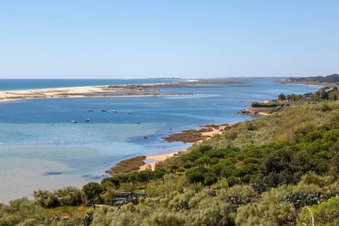 Coastal wooded landscape of pristine beaches and lagoon behind offshore sandbar, Cacela Velha, Vila