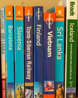 Close up of various travel guide books published by Lonely Planet, Rough Guides, Brandt