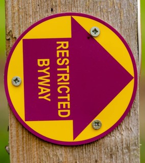 Macro close up of Restricted Byway sign on fencepost, Sutton, Suffolk, UK